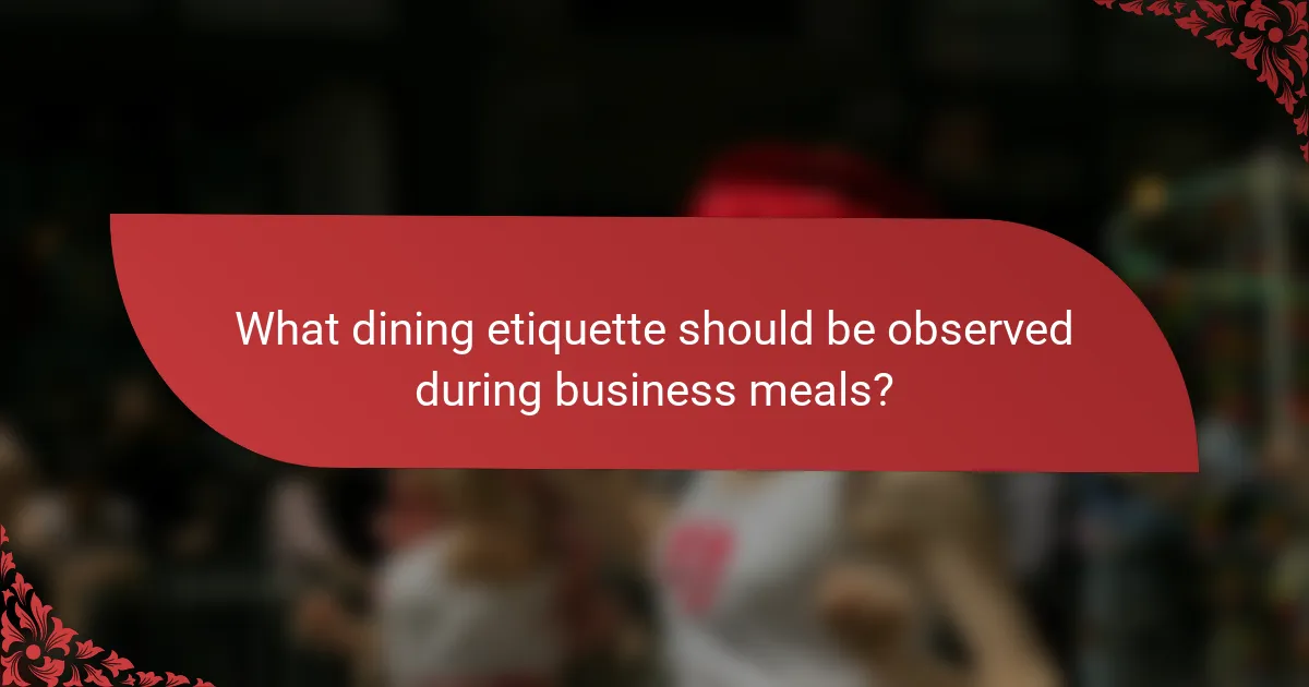What dining etiquette should be observed during business meals?
